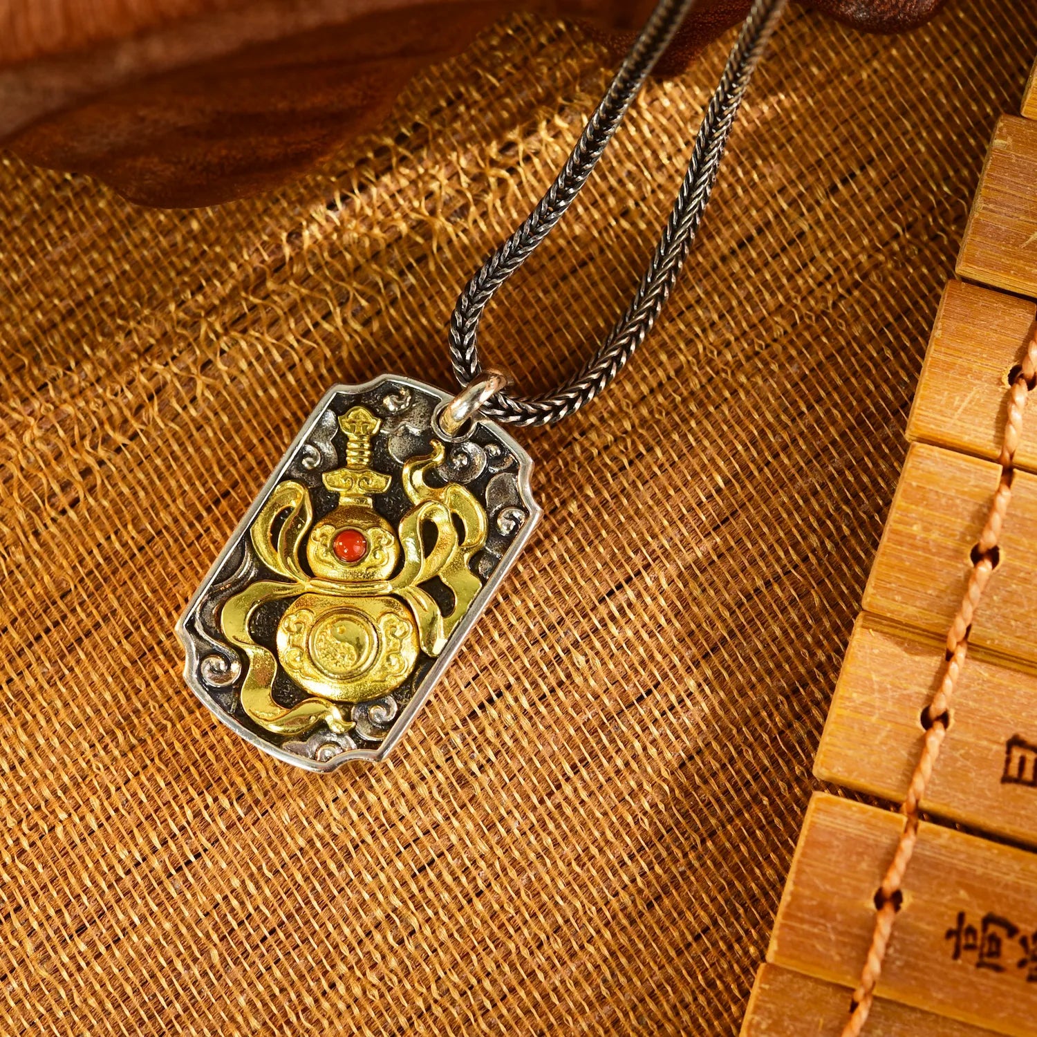 The Warding Talisman pendant front view — handcrafted sword and gourd design with warding motifs — DAO Chant